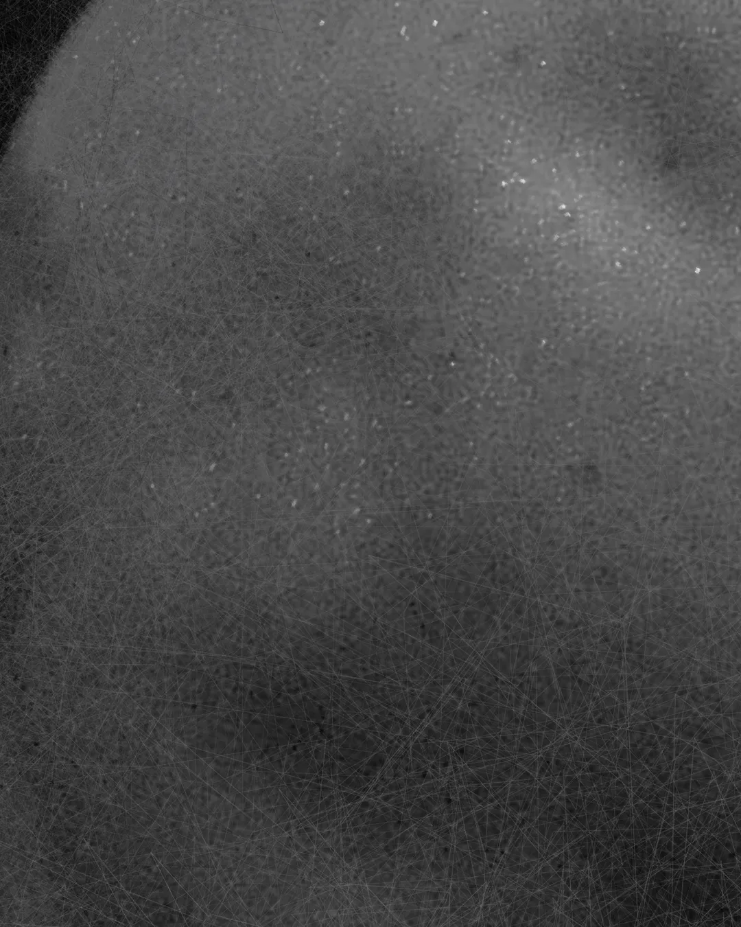 Inquadratura ravvicinata sulla grana materica e le ombre profonde dell'opera contemporanea