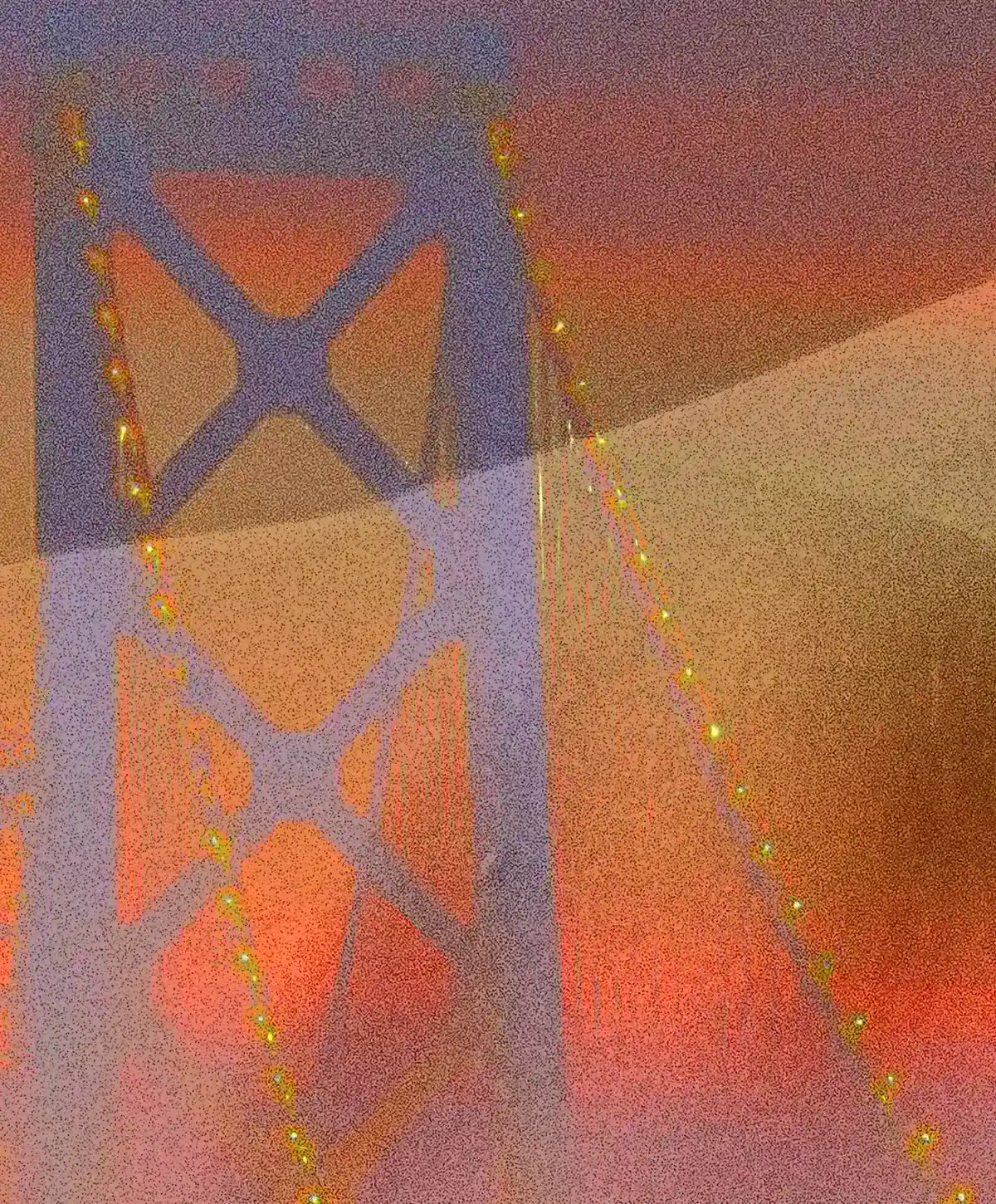 Close-up detail of Vele dorate: the metallic tower of the bridge and the illuminated cables merge with the softness and golden texture of the human body