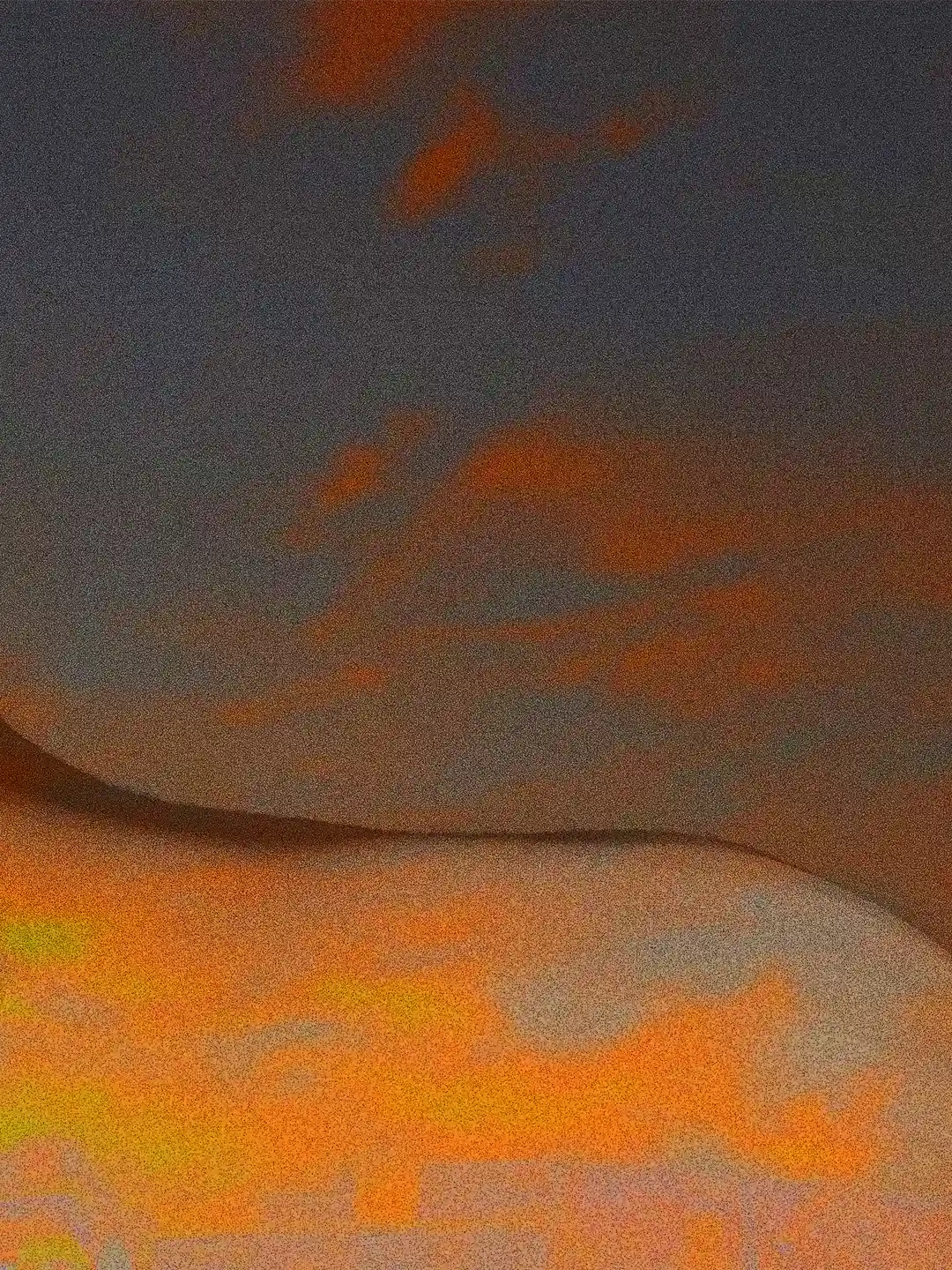 Detail of the artwork Vestigia: the soft line of a human body in digital painting standing out against a night sky, revealing warm orange hues